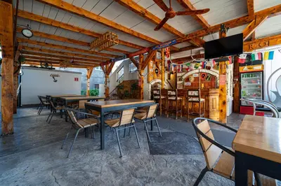 a dining room with wooden tables and chairs at Delfin Apartments in Sutomore