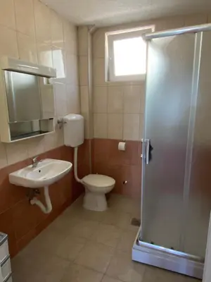 a bathroom with a toilet and a sink and a shower at Pink Holiday House Sutomore in Zankovići