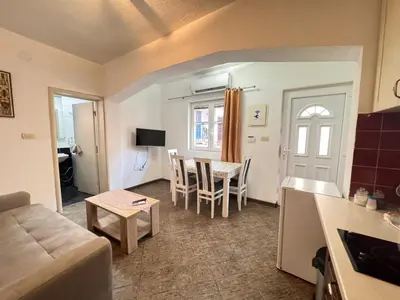 a living room with a couch and a table at Mystras Apartments in Kotor
