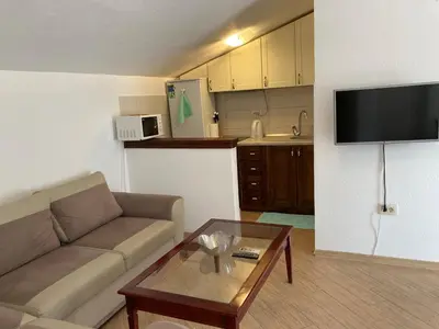 a living room with a couch and a coffee table at Mystras Apartments in Kotor