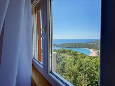 a window with a view of a beach and the ocean at One-bedroom Apart, with panoramic view, Prijevor in Prijevor