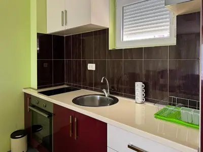 a kitchen counter with a sink and a window at One-bedroom Apart, with panoramic view, Prijevor in Prijevor
