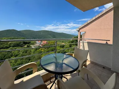 a table and chairs on a balcony with a view at One-bedroom Apart, with panoramic view, Prijevor in Prijevor