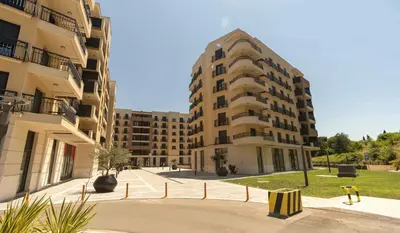 an empty street in front of two apartment buildings at Montenegro Luxury Studio - Hill Homes in Podgorica