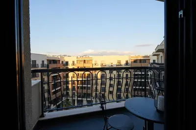 a view of a balcony with tables and chairs at Montenegro Luxury Studio - Hill Homes in Podgorica