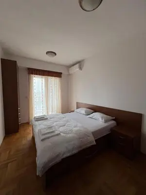 a bedroom with two twin beds and a window at Apartman Marina in Podgorica