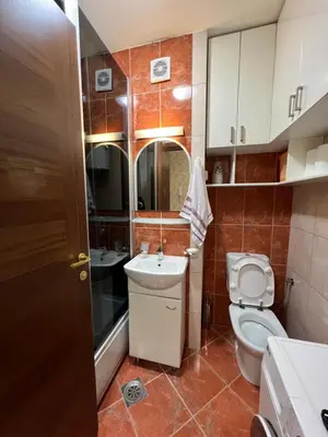 a small bathroom with a toilet and a sink at Apartman Marina in Podgorica