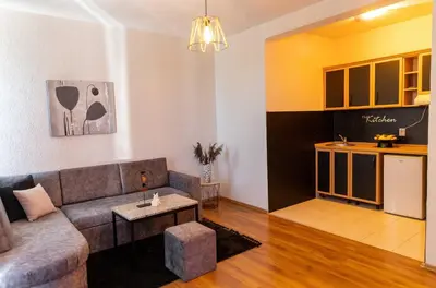 a living room with a couch and a kitchen at Sunshine Apartments in Ulcinj