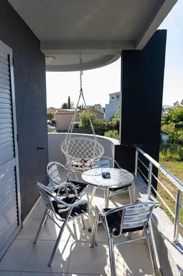 a patio with a table and chairs on a balcony at Sunshine Apartments in Ulcinj