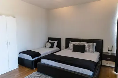 a bedroom with two beds and a window at Sunshine Apartments in Ulcinj