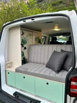 a back of a van with a couch in the back at Eagle's path campers Montenegro in Podgorica