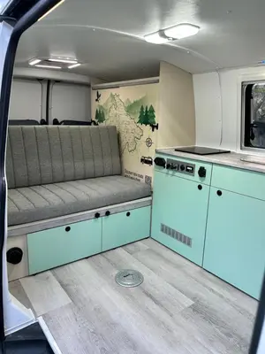 an interior view of an rv with a couch and a stove at Eagle's path campers Montenegro in Podgorica