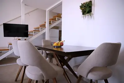a dining room with a wooden table and chairs at Apartments Danica in Petrovac na Moru