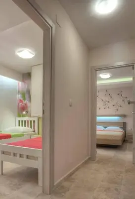 a room with a mirror and a bedroom with a bed at Apartments Danica in Petrovac na Moru