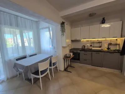 a kitchen with a table and a table and chairs at Cozy apartment in Petrovac in Petrovac na Moru