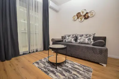 a living room with a couch and a table at Studio Dobra Voda 4 in Dobra Voda