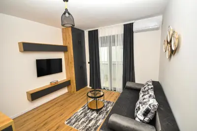 a living room with a couch and a tv at Studio Dobra Voda 4 in Dobra Voda