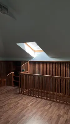 a room with a ceiling with a skylight and a wooden floor at Beachfront Four Bedroom Apartment in Sveti Stefan