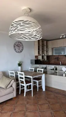 a kitchen and dining room with a table and chairs at Beachfront Four Bedroom Apartment in Sveti Stefan