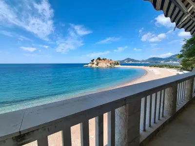 a view of the beach from a balcony at Beachfront Four Bedroom Apartment in Sveti Stefan