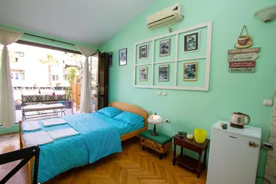 a bedroom with a bed in a room with blue walls at Studio Mimi City Center Bar in Bar