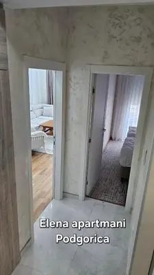 a mirror in a room with a bedroom at Elena apartmani Podgorica in Podgorica