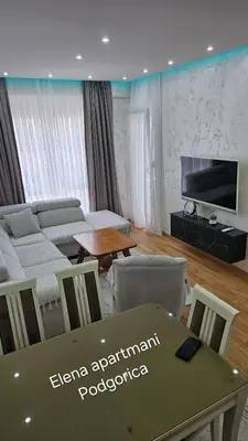 a living room with a couch and a table at Elena apartmani Podgorica in Podgorica