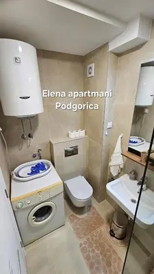 a small bathroom with a toilet and a sink at Elena apartmani Podgorica in Podgorica