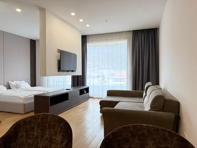 a hotel room with a bed and a tv at Apartment WOW Budva - With free parking in Budva