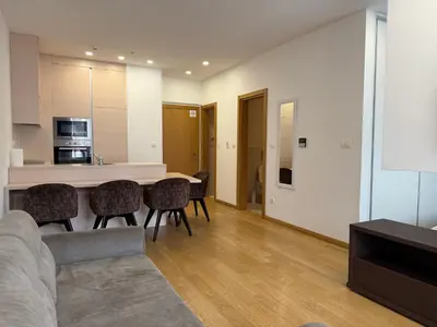 a kitchen and living room with a table and chairs at Apartment WOW Budva - With free parking in Budva