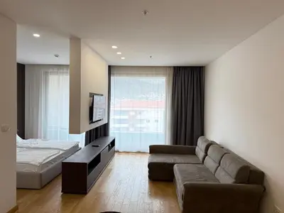 a living room with a couch and a bed at Apartment WOW Budva - With free parking in Budva