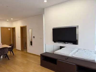 a room with a bed with a flat screen tv on the wall at Apartment WOW Budva - With free parking in Budva