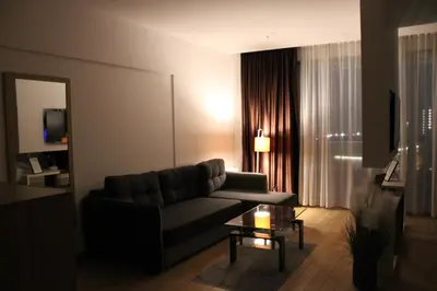 a living room with a couch and a table at WoW APARTMENT'S 604-607 in Budva