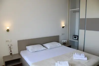 a bedroom with a bed with two towels on it at WoW APARTMENT'S 604-607 in Budva