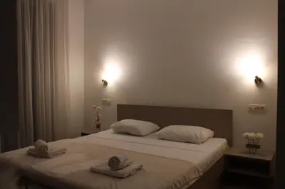 a bedroom with a bed with towels on it at WoW APARTMENT'S 604-607 in Budva