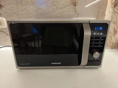 a microwave oven sitting on top of a counter at Peaceful 2bd apartment near Sveti Stefana in Pržno