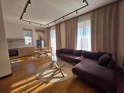 a living room with a couch and a table at Peaceful 2bd apartment near Sveti Stefana in Pržno