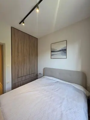a bedroom with a large white bed in it at Peaceful 2bd apartment near Sveti Stefana in Pržno