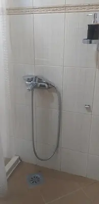 a shower in a bathroom with a hose on a wall at TALi in Ulcinj