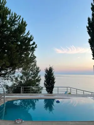 a swimming pool with a view of the ocean at TALi in Ulcinj