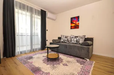a living room with a couch and a table at Studio Dobra Voda 13 in Dobra Voda