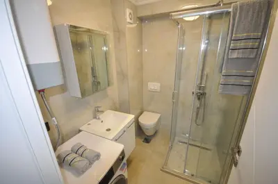 a bathroom with a shower and a sink and a toilet at Studio Dobra Voda 13 in Dobra Voda