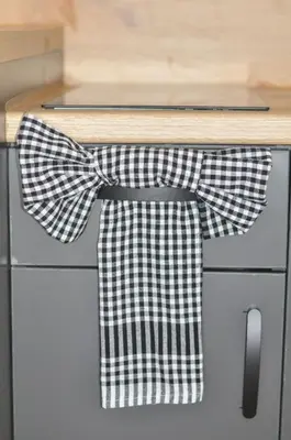 a black and white bow tie on a kitchen counter at Studio Dobra Voda 13 in Dobra Voda
