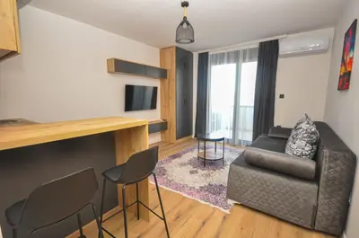a living room with a couch and a chair at Studio Dobra Voda 13 in Dobra Voda