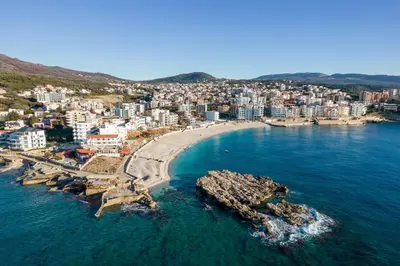 an aerial view of a beach with buildings and the ocean at Studio Dobra Voda 13 in Dobra Voda
