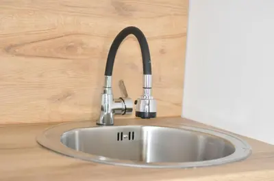 a stainless steel sink in a counter top at Studio Dobra Voda 13 in Dobra Voda