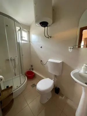 a bathroom with a toilet and a shower and a sink at Apartments Manojlovic in Budva