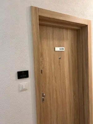 a door with a sign on it next to a wall at Sea La Vie in Bar