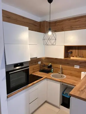 a kitchen with white cabinets and a sink at Sea La Vie in Bar