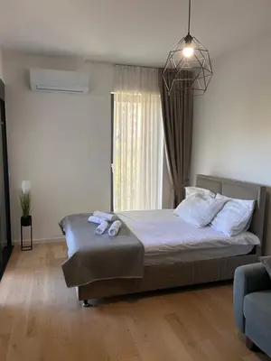 a bedroom with a bed with two towels on it at Sea La Vie in Bar